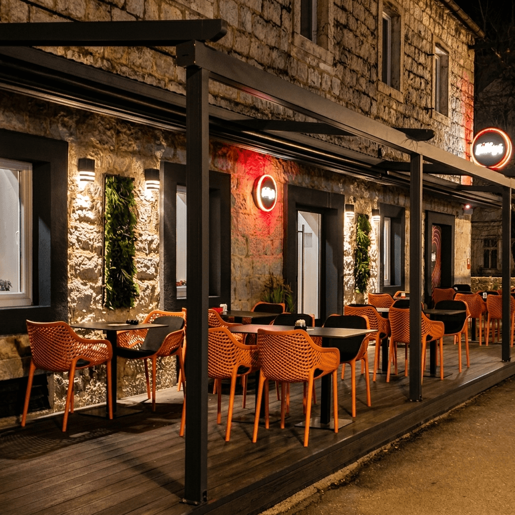 The warmly lit terrace and exterior of Lilly's Trebinje in the evening.